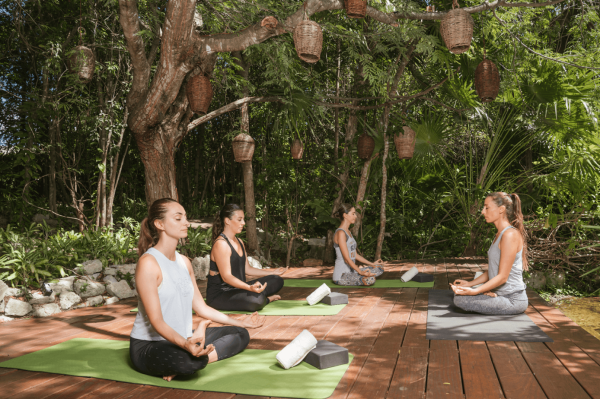 yoga session on a dock by the canals of mayakoba